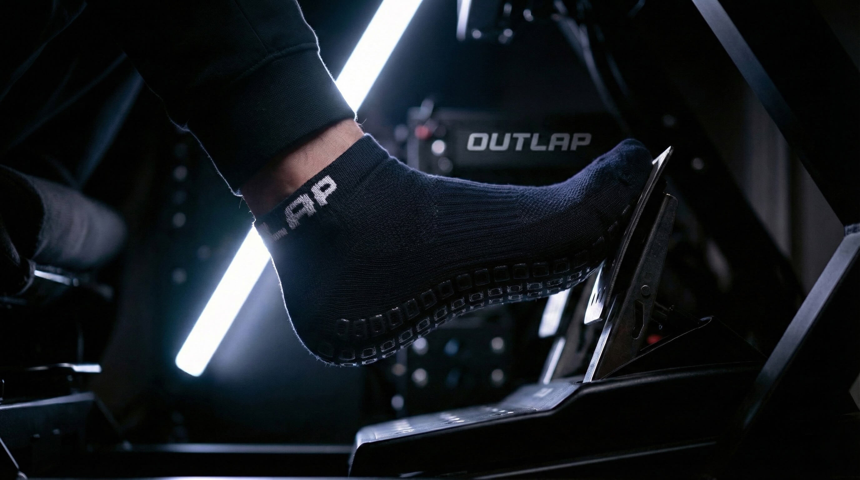 Outlap NitroGrip Obsidian Sim Racing Socks with white led strip in background