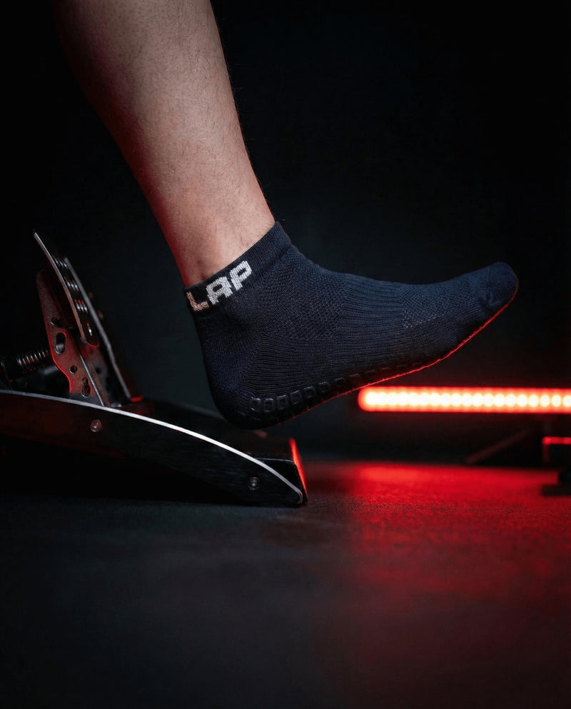 Outlap NitroGrip Obsidian Sim Racing Socks with red led light in the background